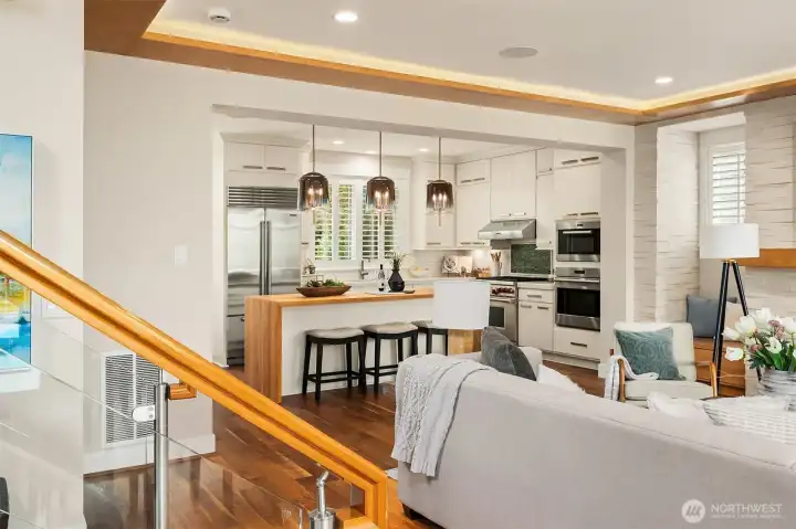 A carefully curated palette of walnut, natural stone, glass, and crisp white millwork creates a timeless architectural statement. From the striking glass staircase to the stacked stone fireplace and chef's kitchen beyond, every detail was designed to feel beautifully connected. A carefully curated palette of walnut, natural stone, glass, and crisp white millwork creates a timeless architectural statement. From the striking glass staircase to the stacked stone fireplace and chef's kitchen beyond, every detail was designed to feel beautifully connected.