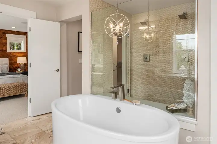 Relax and unwind in the spa-inspired primary bath, where a freestanding soaking tub, oversized frameless glass shower, heated travertine flooring, and designer lighting create a refined sanctuary for everyday indulgence. Relax and unwind in the spa-inspired primary bath, where a freestanding soaking tub, oversized frameless glass shower, heated travertine flooring, and designer lighting create a refined sanctuary for everyday indulgence.