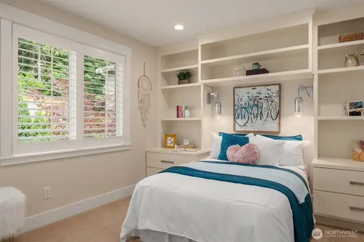 Tailored built-in cabinetry transforms this upper-level bedroom into a custom-designed retreat, seamlessly integrating bedside storage, open display shelving, and furniture-quality millwork that maximizes both beauty and functionality. Tailored built-in cabinetry transforms this upper-level bedroom into a custom-designed retreat, seamlessly integrating bedside storage, open display shelving, and furniture-quality millwork that maximizes both beauty and functionality.