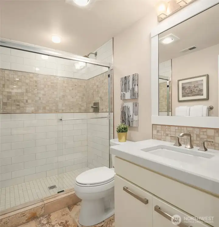Serving the adjacent media room or optional fourth bedroom, this beautifully appointed ¾ bath features timeless travertine tile and a spacious walk-in shower—perfect for guests and everyday comfort. Serving the adjacent media room or optional fourth bedroom, this beautifully appointed ¾ bath features timeless travertine tile and a spacious walk-in shower—perfect for guests and everyday comfort.