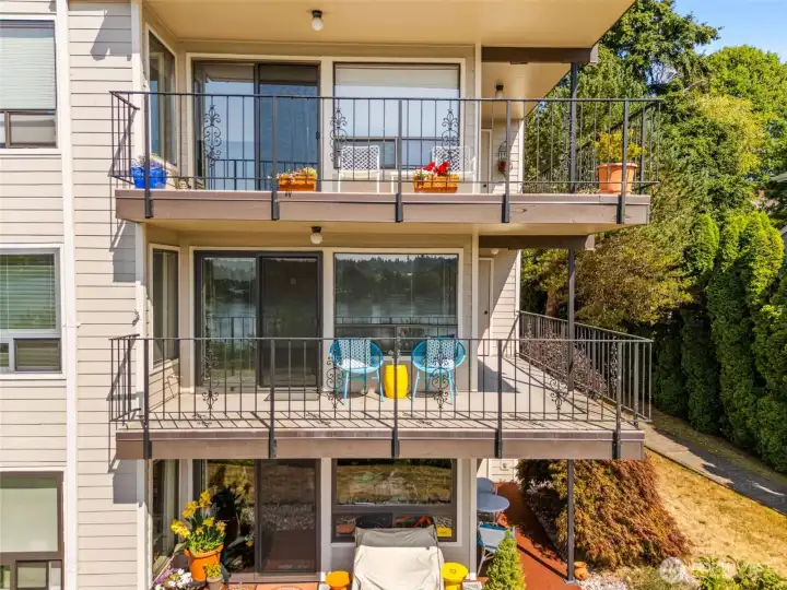 Front view of the balcony/patio (teal chairs) showing the wrap-around patio and storage closet on the right side of the balcony. Front view of the balcony/patio (teal chairs) showing the wrap-around patio and storage closet on the right side of the balcony.
