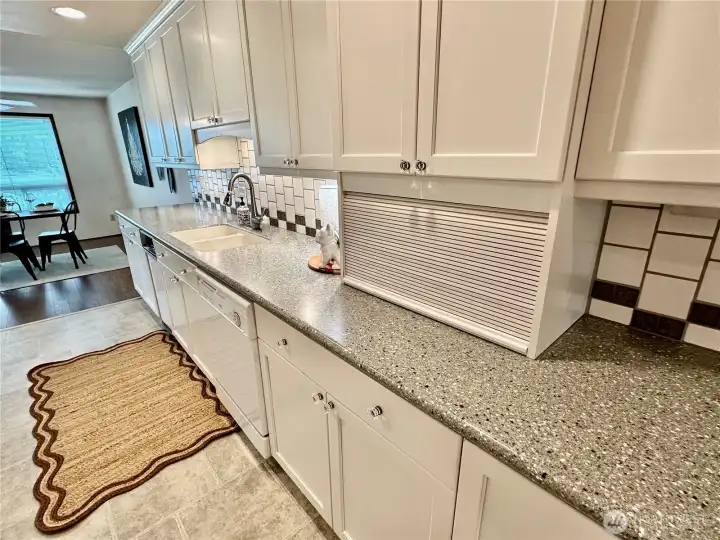 Another view of the kitchen, complete with Corian counters with full height tile back splash and appliance garage storage. Another view of the kitchen, complete with Corian counters with full height tile back splash and appliance garage storage.