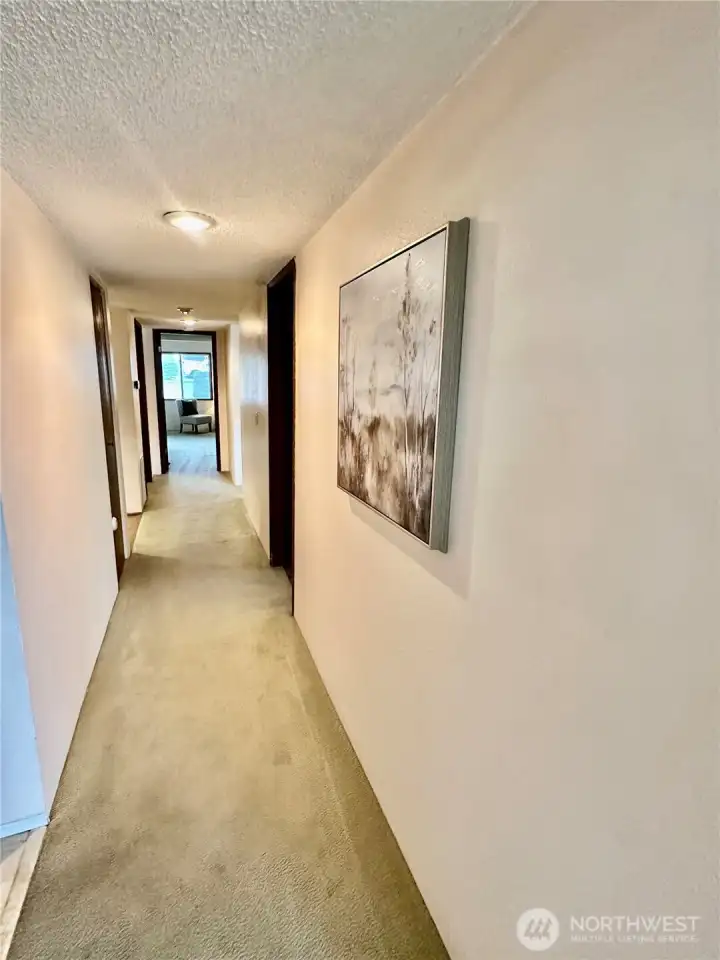 Looking down the hall toward the bedrooms and guest bath. Looking down the hall toward the bedrooms and guest bath.