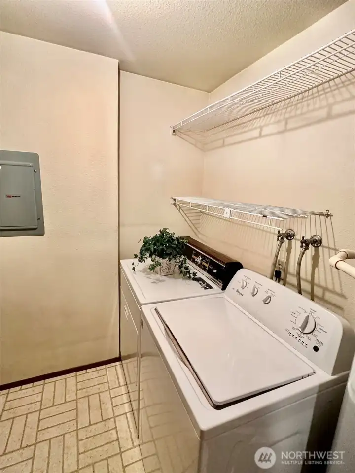 Laundry room with upper shelves for storage space. Laundry room with upper shelves for storage space.