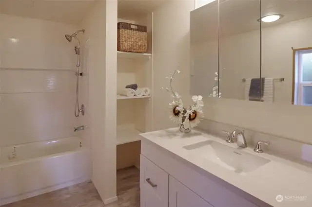 Beautifully remodeled primary bathroom with new cabinet, sink, faucet, tub & toilet.