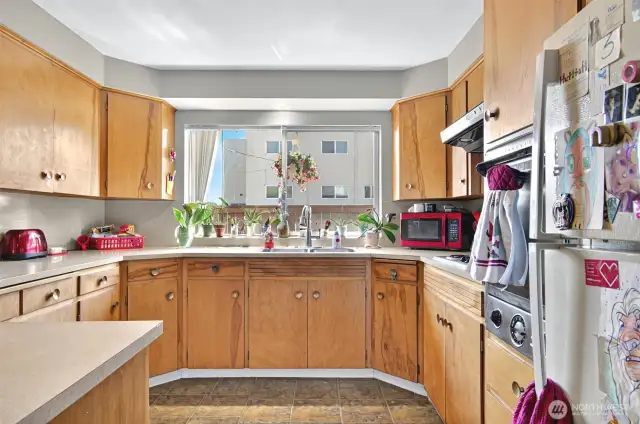 Large kitchen with original cabinetry as well as original oven and stove top