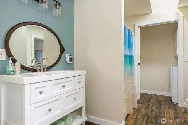Vanity and shower, looking towards laundry.
