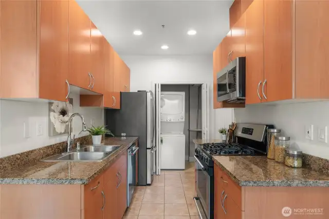 Kitchen with granite countertops, pantry and in-unit laundry