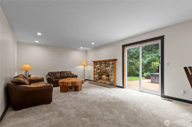 Kitchen opens to the family room with a river rock fireplace and slider to the back yard.