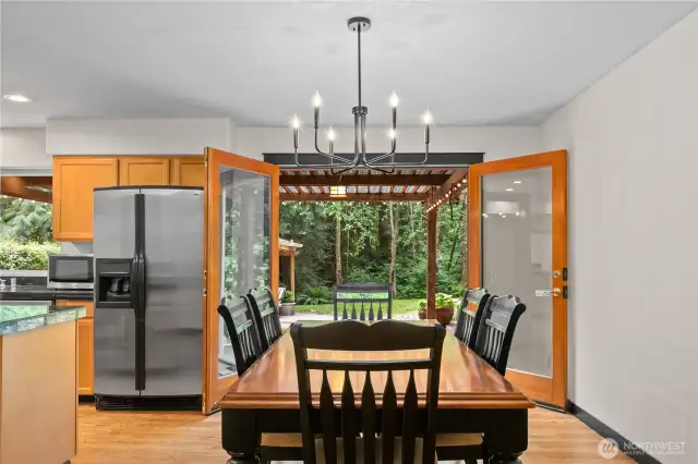 Dining room's French doors open to the ultra-private back yard