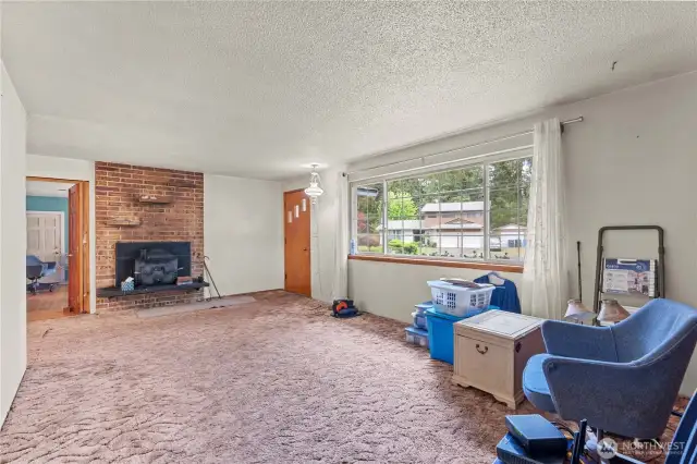 Original/main living room off the entrance with wood burning fireplace