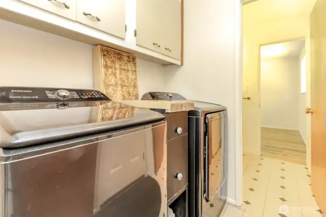 Laundry room with new washer and dryer that stay with home.