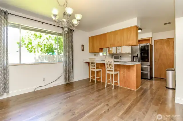 Nice sized dining area looking into kitchen and large backyard.