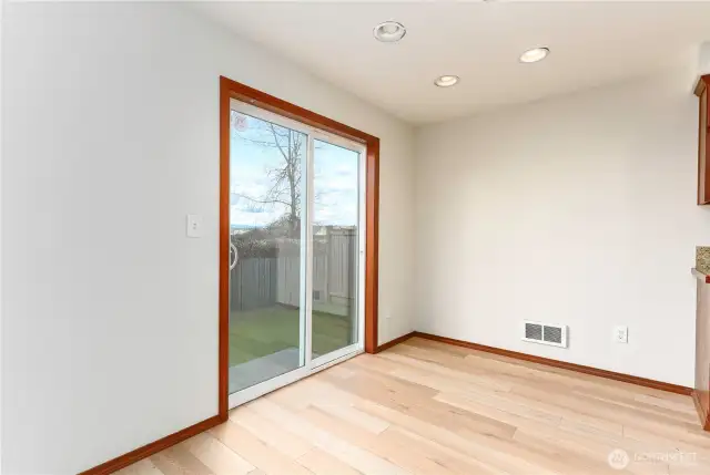 dining room with sliding door to back patio and fully fenced back yard