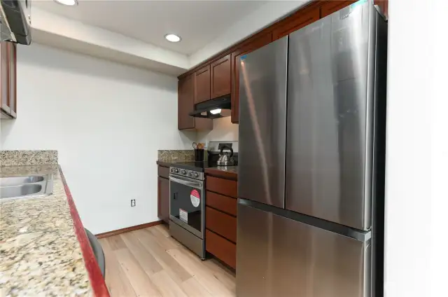 stone tile countertops, new flooring and brand new refrigerator, oven and dishwasher