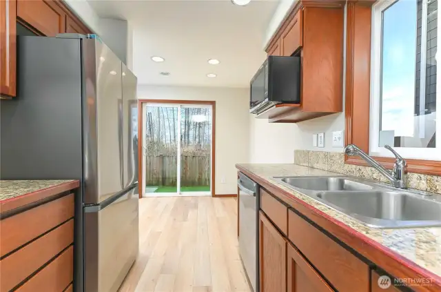 stone tile countertops, new flooring and brand new refrigerator, oven and dishwasher