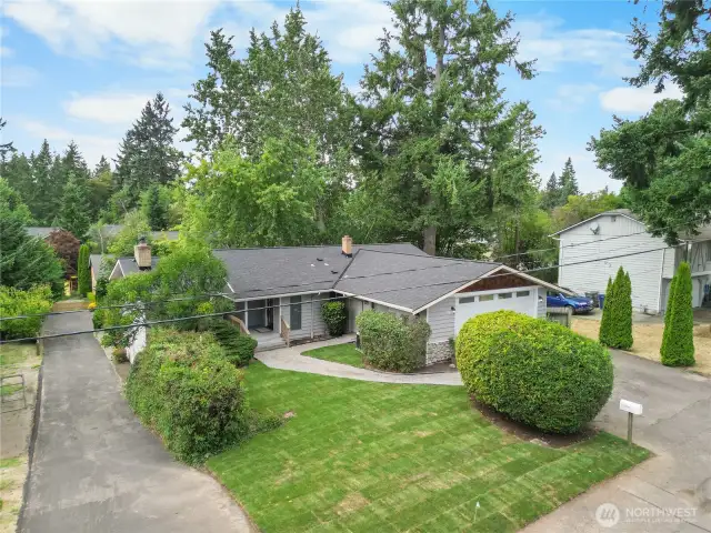 Charming Finn Hill daylight rambler with expansive front yard with mature landscaping.