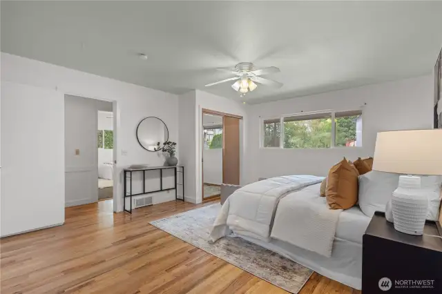 Relaxing primary suite with bright windows.
