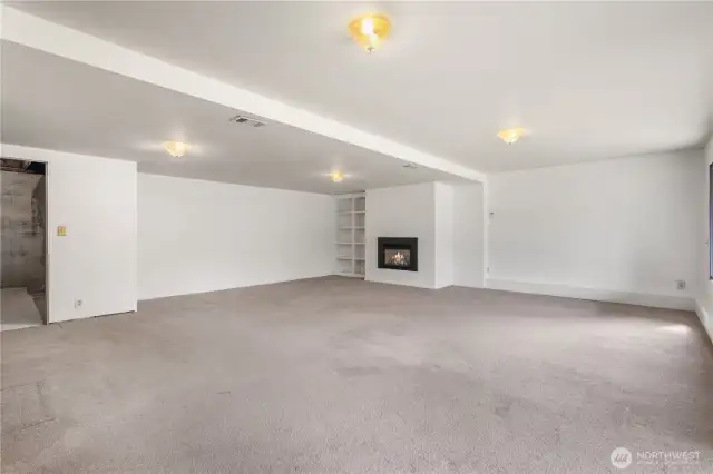 Spacious rec room with fireplace.