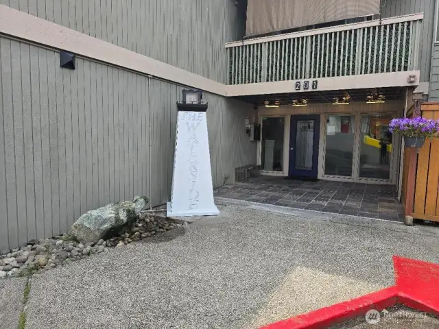 Custom built lighthouse sign and rock water feature at entrance of the building