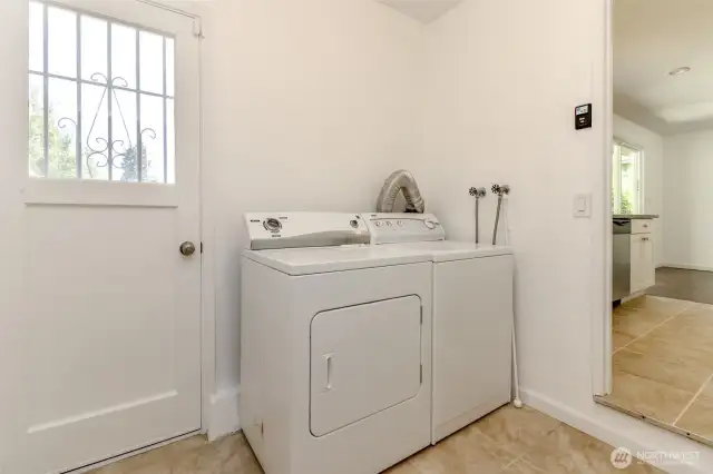 laundry room with man door leading outside