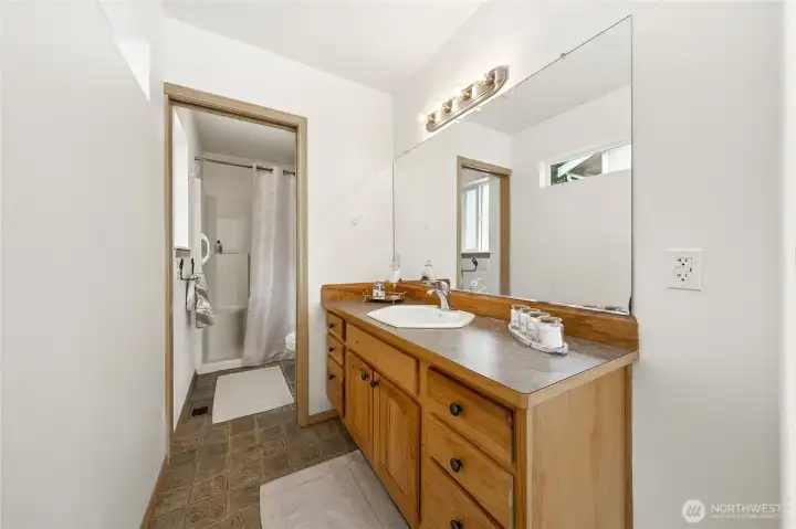 Private primary ensuite with large vanity and separate water closet with toilet and shower.