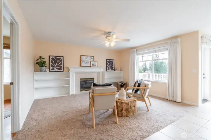 Soft carpet in family room with gas fireplace and shelving for your photos, books, baskets, etc.