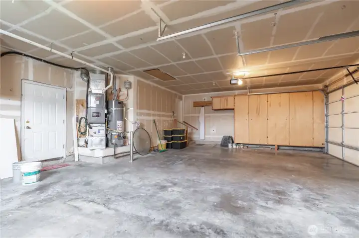 Easy access to water heater and furnace recently serviced and installed. Furnace (2021), Water Heater (2018), and AC located just outside of back garage door.  Lots of storage space.