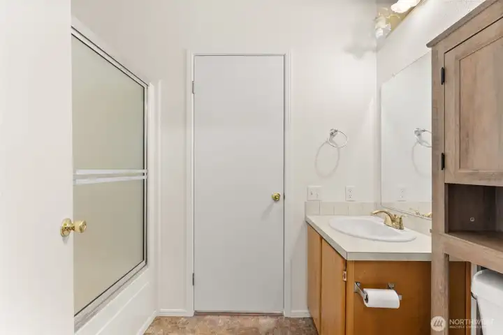 Main Bath with entrance into laundry area.