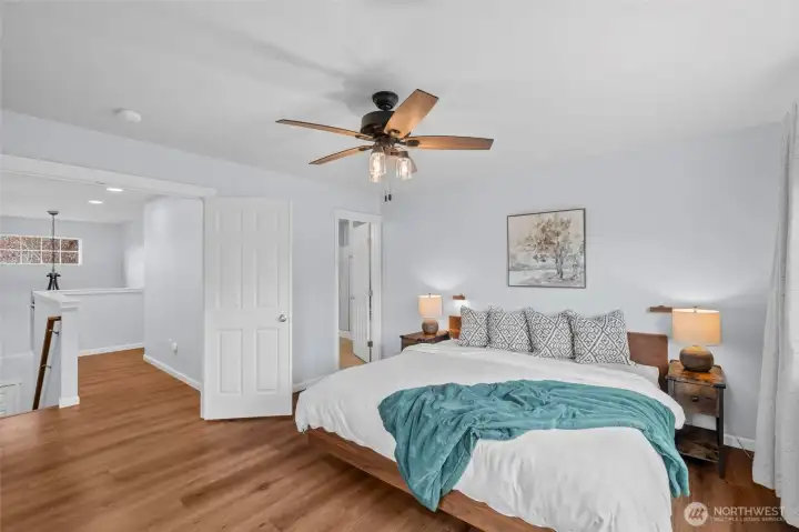 2ND FLOOR PRIMARY BEDROOM SUITE | At the top of the stairs, you're greeted by an impressive double-door entry into the primary bedroom. This spacious room sits at the back of the home and features laminate flooring, a ceiling fan and connected bathroom.