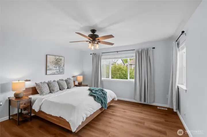 SPACIOUS PRIMARY BEDROOM | Overlooking the back yard, this primary bedroom has space for seating so you can enjoy not only sleeping, but create a private corner of the home to call your own.