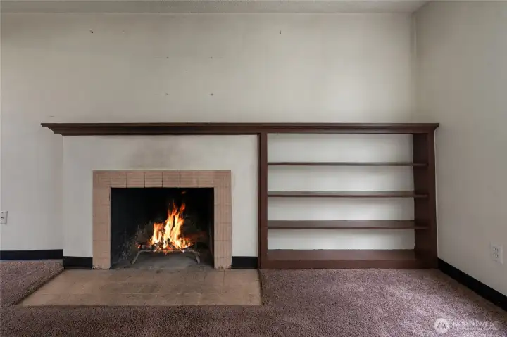 Notice the original shelving and tile around the fireplace.
