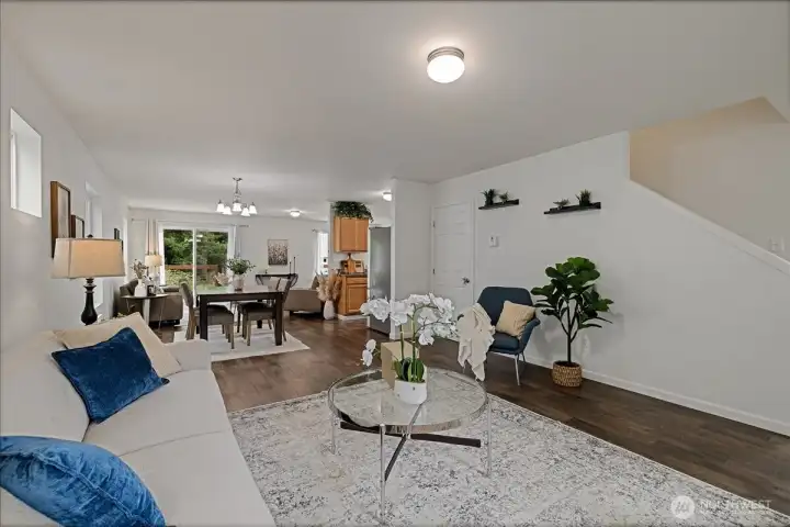 Looking towards the back of the home & kitchen, even more main floor living space around the corner.