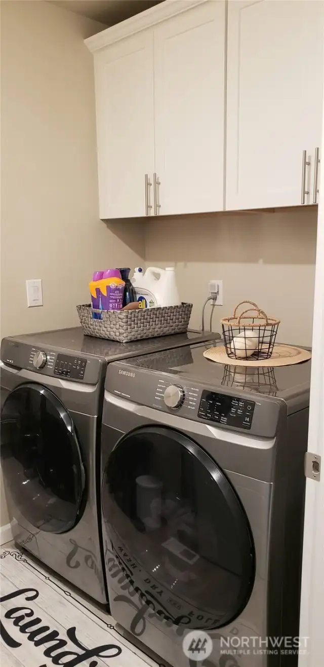 Utility Room Showing White Over head Storage Cabinets.