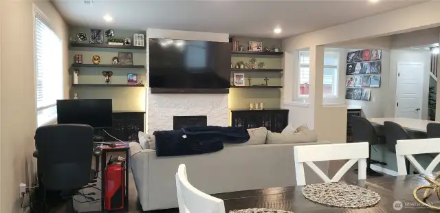 View of the Spacious Living Room Showing Full Brick Gas Fireplace from the Dining Room Area.