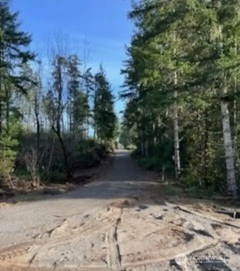 View from the entrance to the lot, facing east up NW Early Bird Rd.