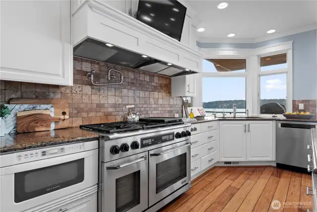 This expertly arranged space features  top-of-the-line appliances, including a  special oven, a spacious island with ample  prep area, and plenty of counter space for all  your culinary needs. High-quality cabinetry  provides abundant storage, keeping  everything organized and within reach.