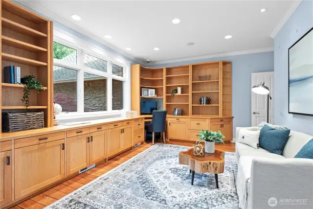 Experience productivity and style in this  beautifully appointed home office, featuring  custom built-in cabinetry that blends form  and function. The elegant cabinetry provides  ample storage and organization for books,  documents, and office essentials, creating a  clutter-free and efficient workspace.