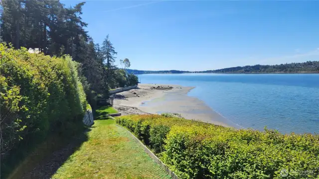 You have your own waterfront lawn for those  special moments that you can only get on  your private waterfront. This could all be  yours—a special place on a private 7-acre  wooded wonderland with fantastic views of  the Puget Sound and Olympic Mountains,  along with your own private beach.