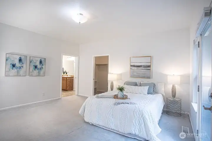 Primary bedroom 1 with bathroom and large closet beyond