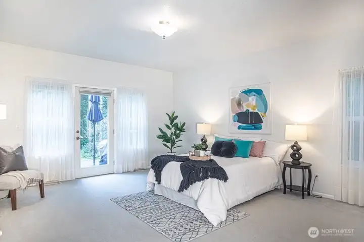 Primary bedroom 2 with door to back deck and lots of natural light