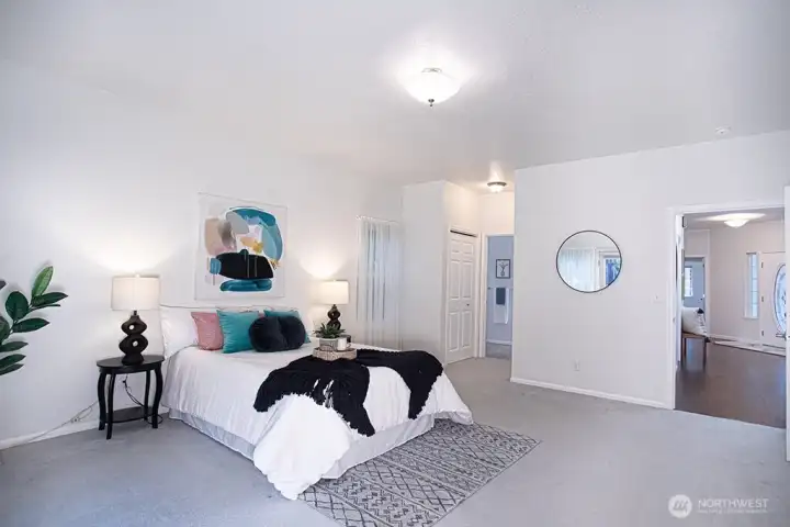 Primary bedroom 2 with two closets and access to bathroom beyond