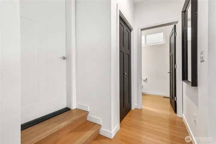 This is the view from the entry of the home. Entry hall is separated from the main living space. Garage door on left.