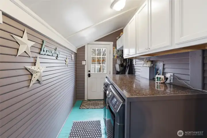 In the rear of the home is an entrance door into the laundry room. Great place to come in easily to remove your shoes, belongings and head to the rest of the home.
