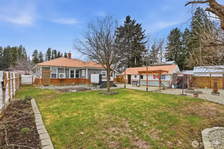 This is a fully fenced back yard with a fire pit, hot tub, green grass area and poured concrete area. It doesn't get any better than this!