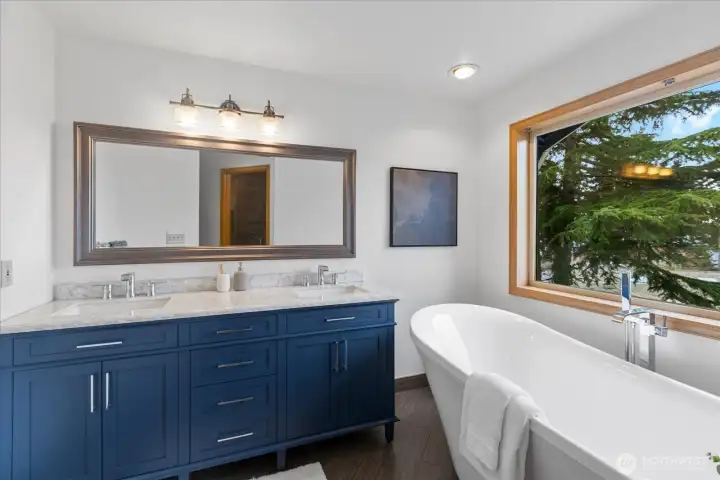 Primary bathroom with dual vanity and modern finishes