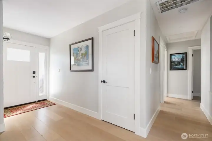 Primary residence entry showing hall to secondary bedrooms, bath and laundry.