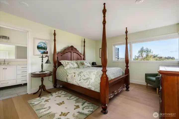 Main residence primary bedroom suite showing entrance to the bath at left. Walk-in closet is at left out of view.