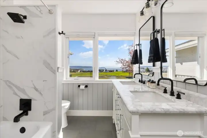 Primary residence main bath has double-sink vanity, tub and shower and amazing Sound and territorial views.