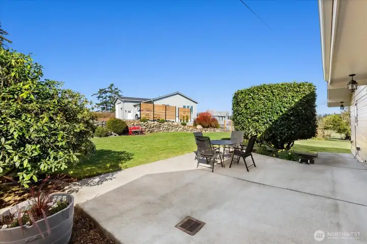Primary Residence Patio with lovely terraced and landscaped yard. Guest cottage is seen in the background.